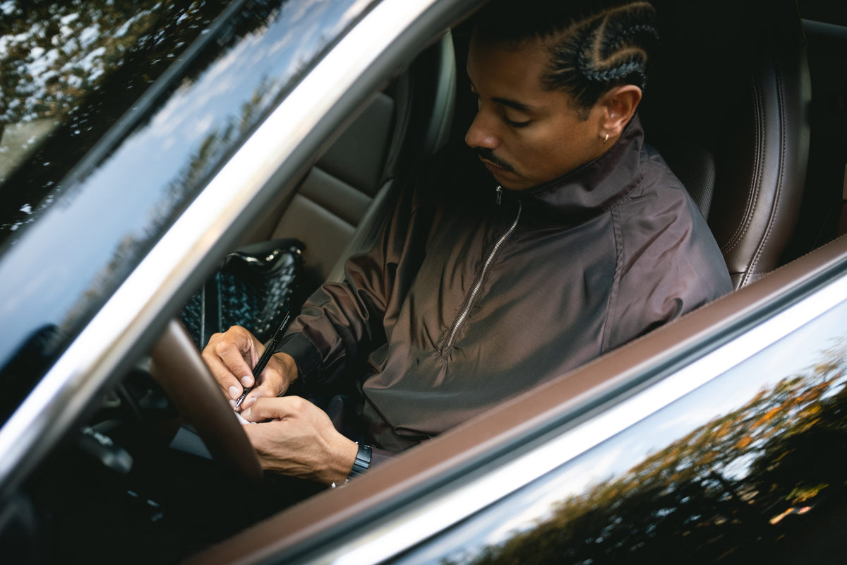 Pierre FW26 campaign, Silk & Nylon Quarter Zip Jacket in Brown, in the car